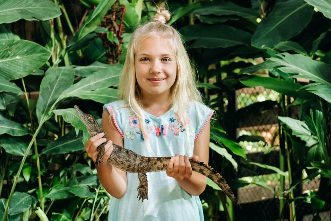 summer-portrait-of-a-happy-little-girl-on-the-island-of-mauritius-with-a-crocodile-girl-at-the-zoo Home